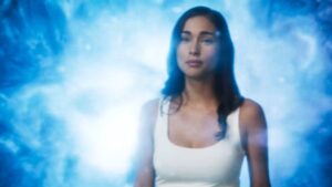 Close up of Priscilla Quintana in Pandora TV series surrounded by space time warp cloud