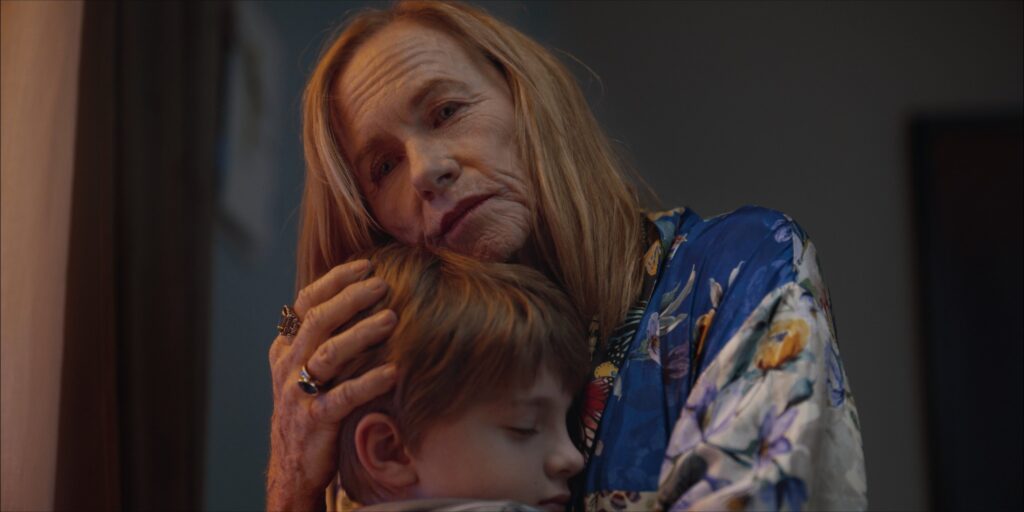 Beauty close up of Academy Award nominated Amy Madigan hugging boy in Go for Grandma film