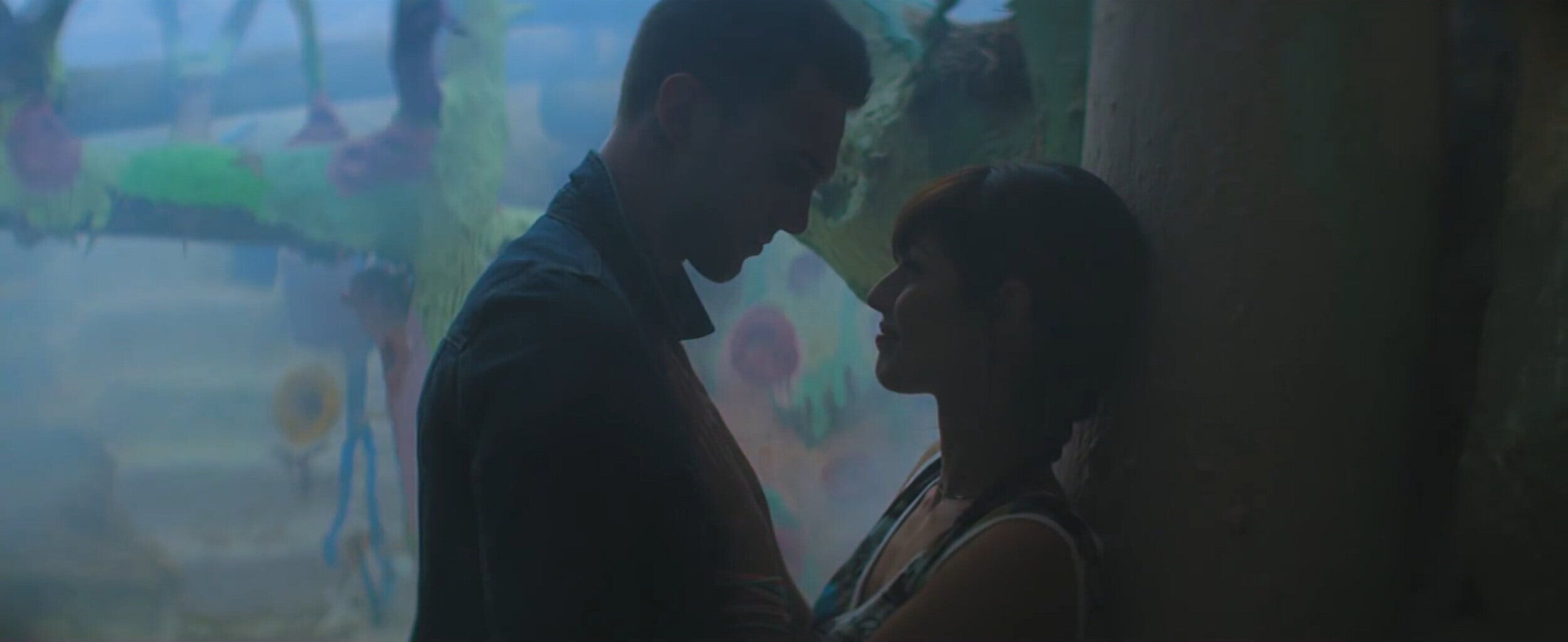 Close up of a man and woman looking at each other in silhouette lighting and in profile