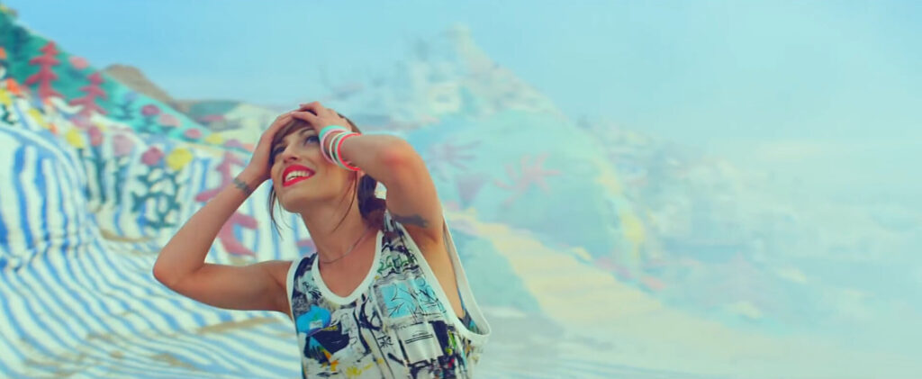 Close up of Jenn Ayache dancing at salvation mountain