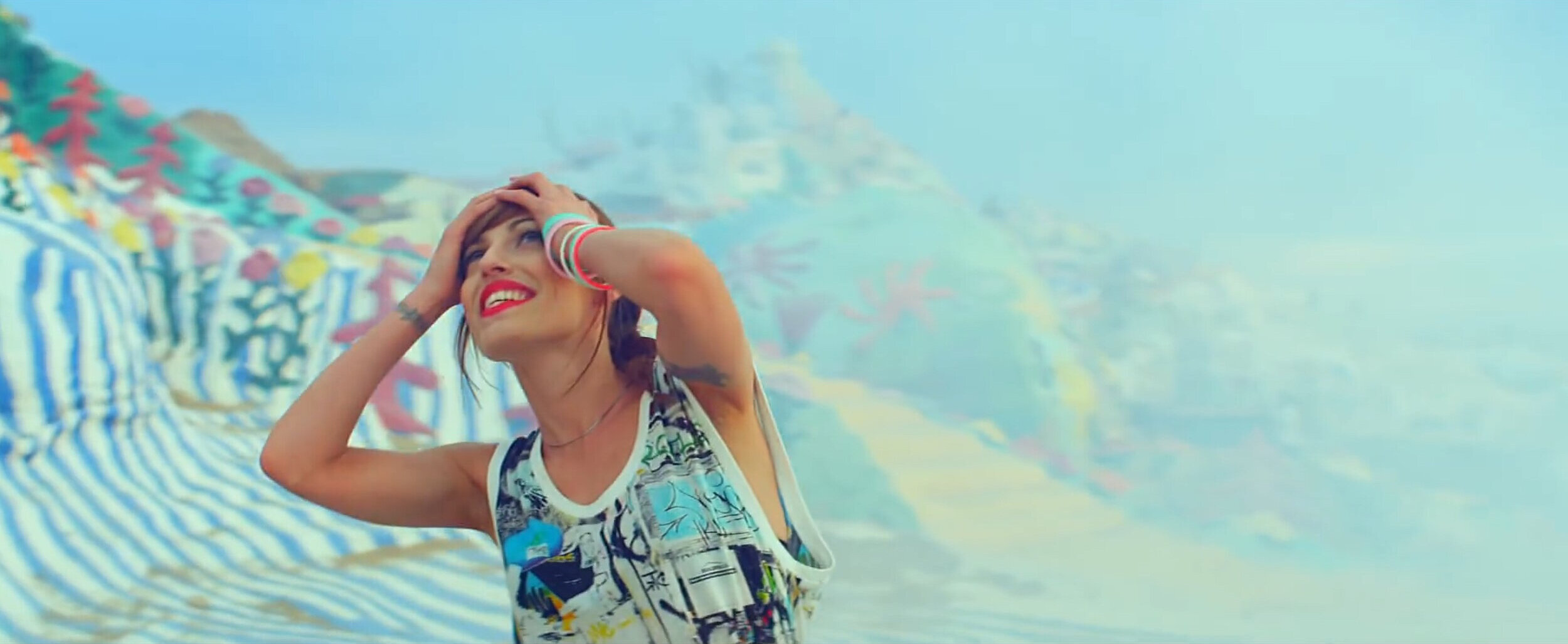 Close up of Jenn Ayache dancing at salvation mountain