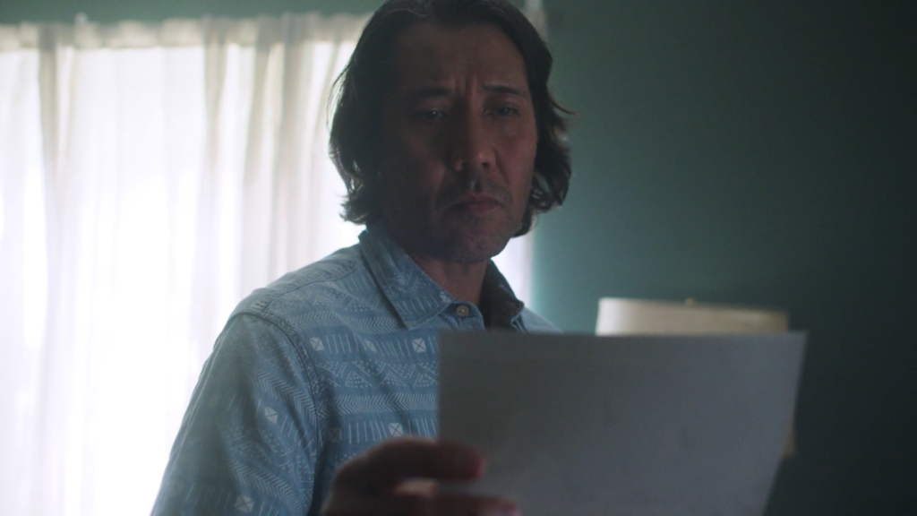 Close up of man looking at a photo in bedroom