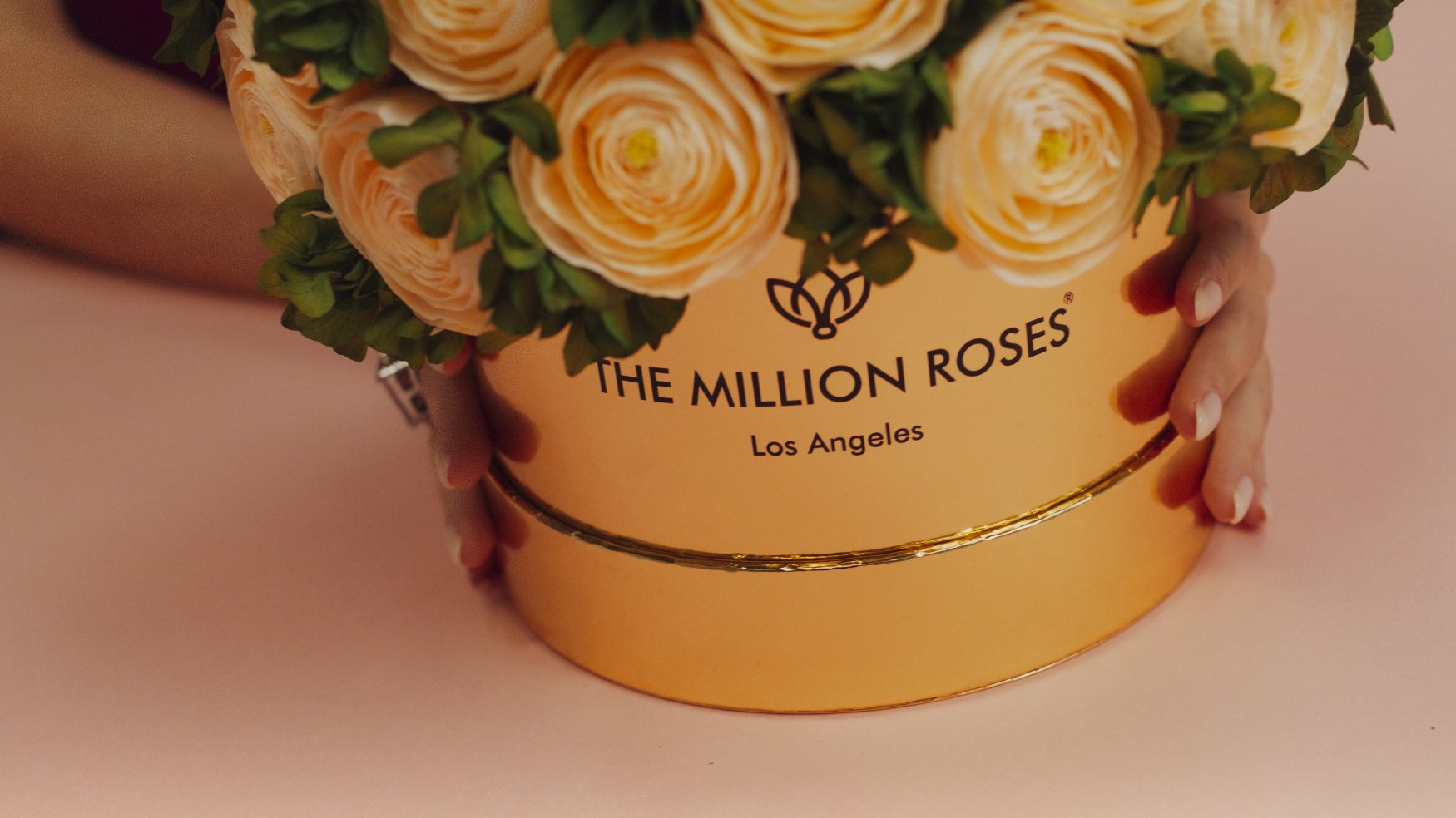 close up shot of the million roses label on flower box in gold