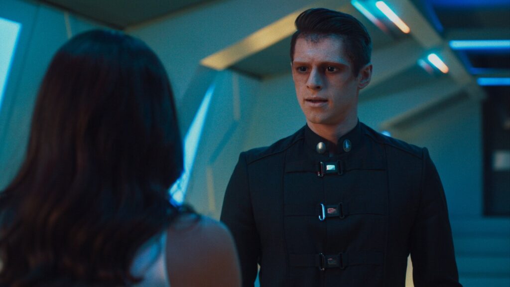 Ben Radcliffe alien movie character in futuristic cyan blue hallway lighting sc-fi tv series Pandora