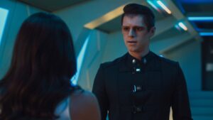 Ben Radcliffe alien movie character in futuristic cyan blue hallway lighting sc-fi tv series Pandora