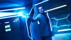 Actor Oliver Dench shooting a plasma laser on spaceship deck of Pandora TV series