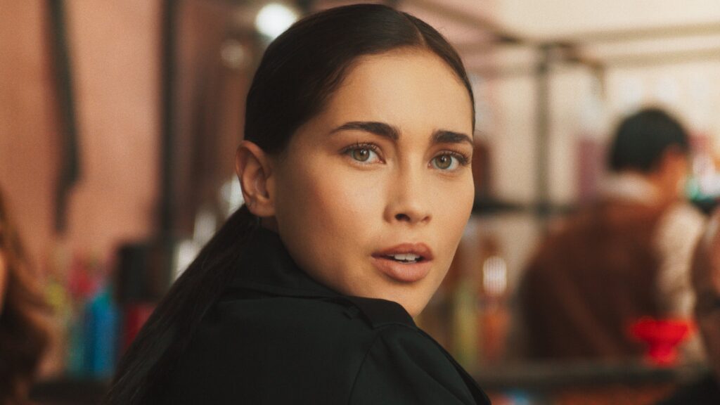 Beauty close up of actress Priscilla Quintana on The CW show looking straight into camera