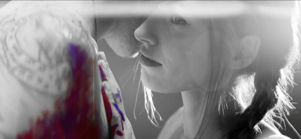 Close up of woman holding another man in black and white photo