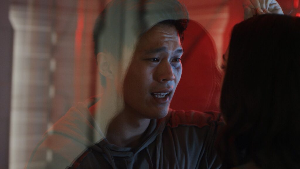 Two people looking at each other through a glass window