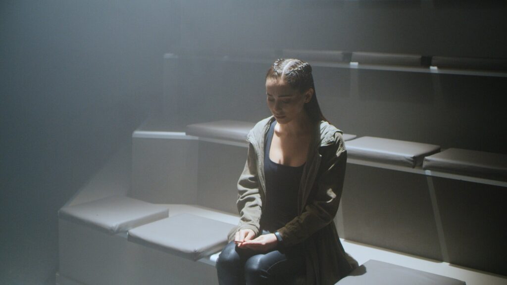 The CW pandora tv series frame of pandora looking down onto her hands in dramatic lighting