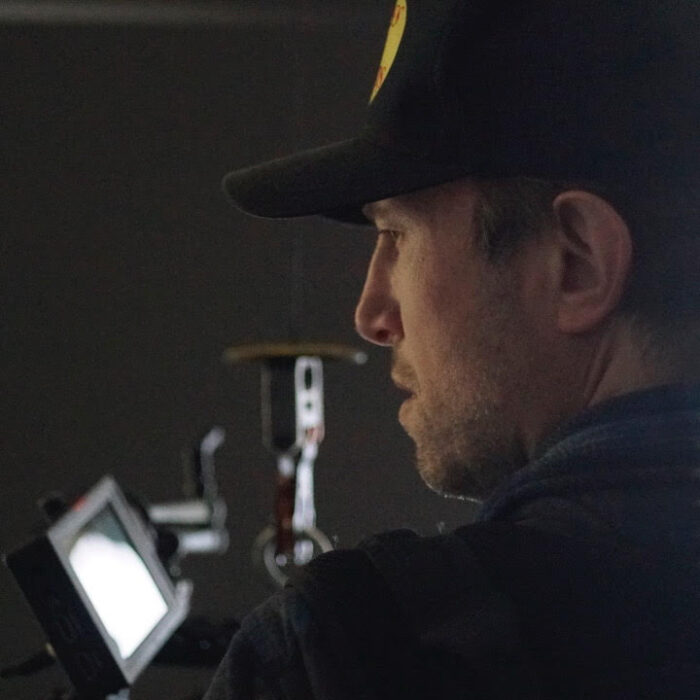 Max Schmige cinematographer over the shoulder operating a camera