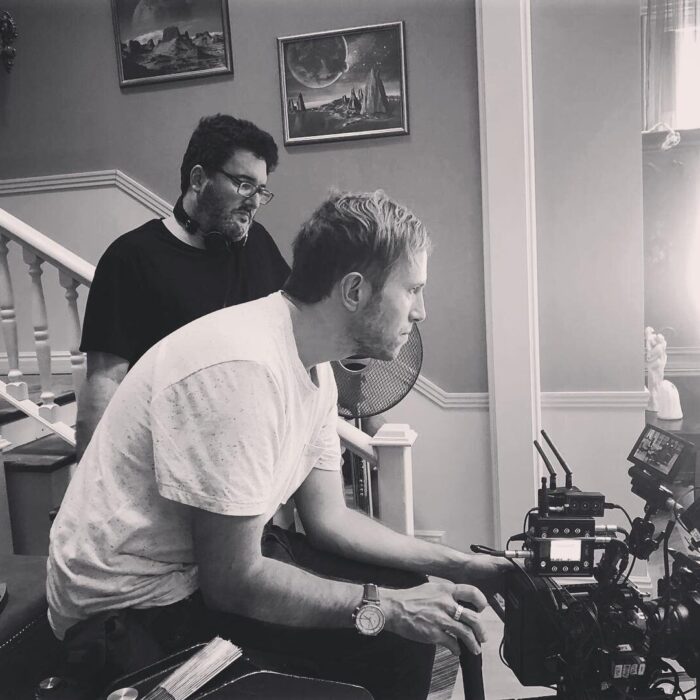 Director of Photography Maximilian Schmige operating camera with director and producer Mark A Altman looking over his shoulder