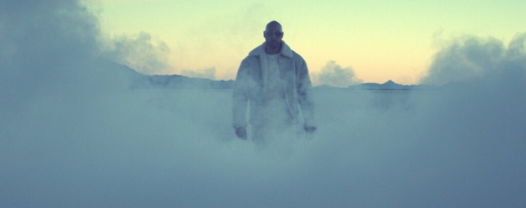 Man walking thtrough thick smoke at magic hour