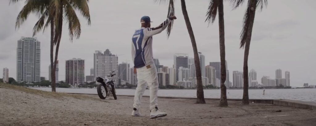 Man standing at beach looking at Miami Skyline