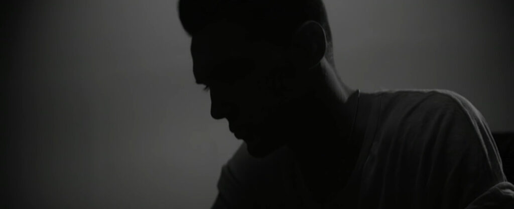 Close up silhouette shot of man in dramatic studio lighting