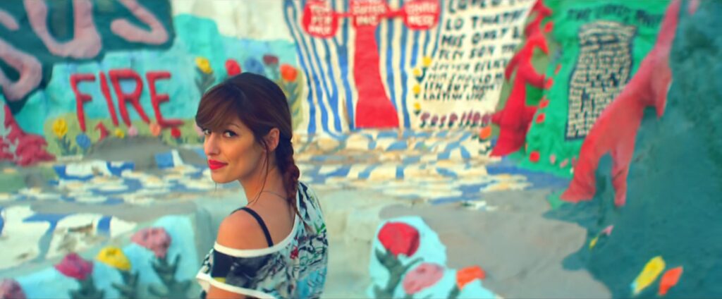 Jenn Ayache looking over her shoulder at Salvation Mountain