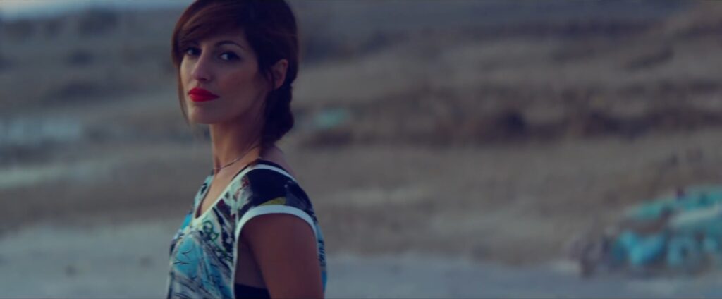 Jenn Ayache looking over her shoulder in magic hour lighting