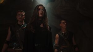 Roxanne McKee in dramatic low angle shot in cave scene from Pandora TV series