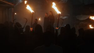 Sci-fi group scene with people holding torches