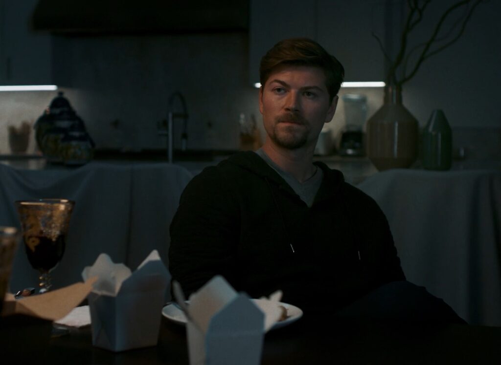 Amadeus Serafini sitting at dining room table at night in Where did the adults go movie