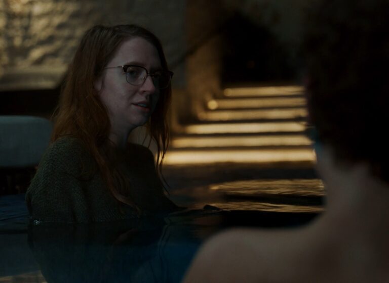 Carey Cox sitting in a hot tub at night