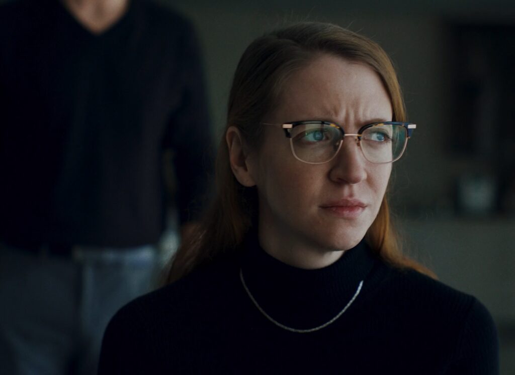 Carey Cox close up looking out a window