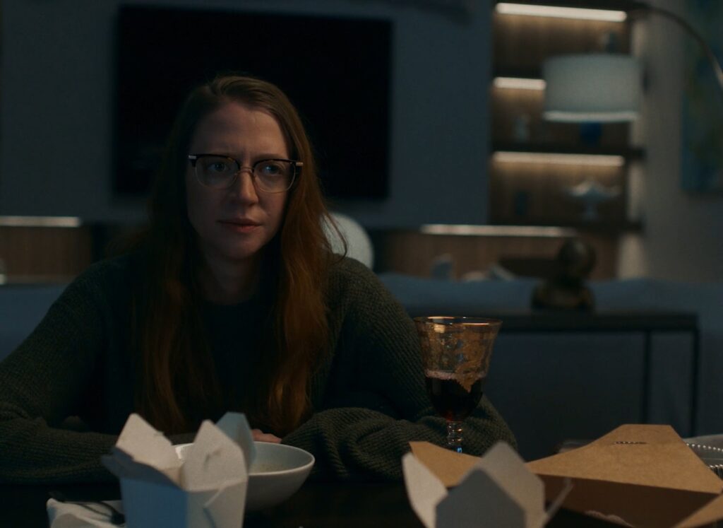Carey Cox sitting at dining room table at night in Where Did the Adults Go movie