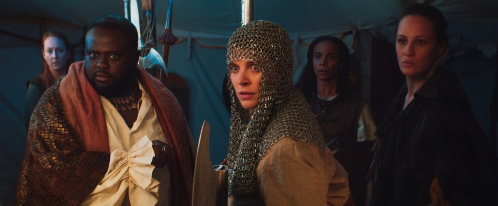 group of people in middle ages knight outfits turning to look at something