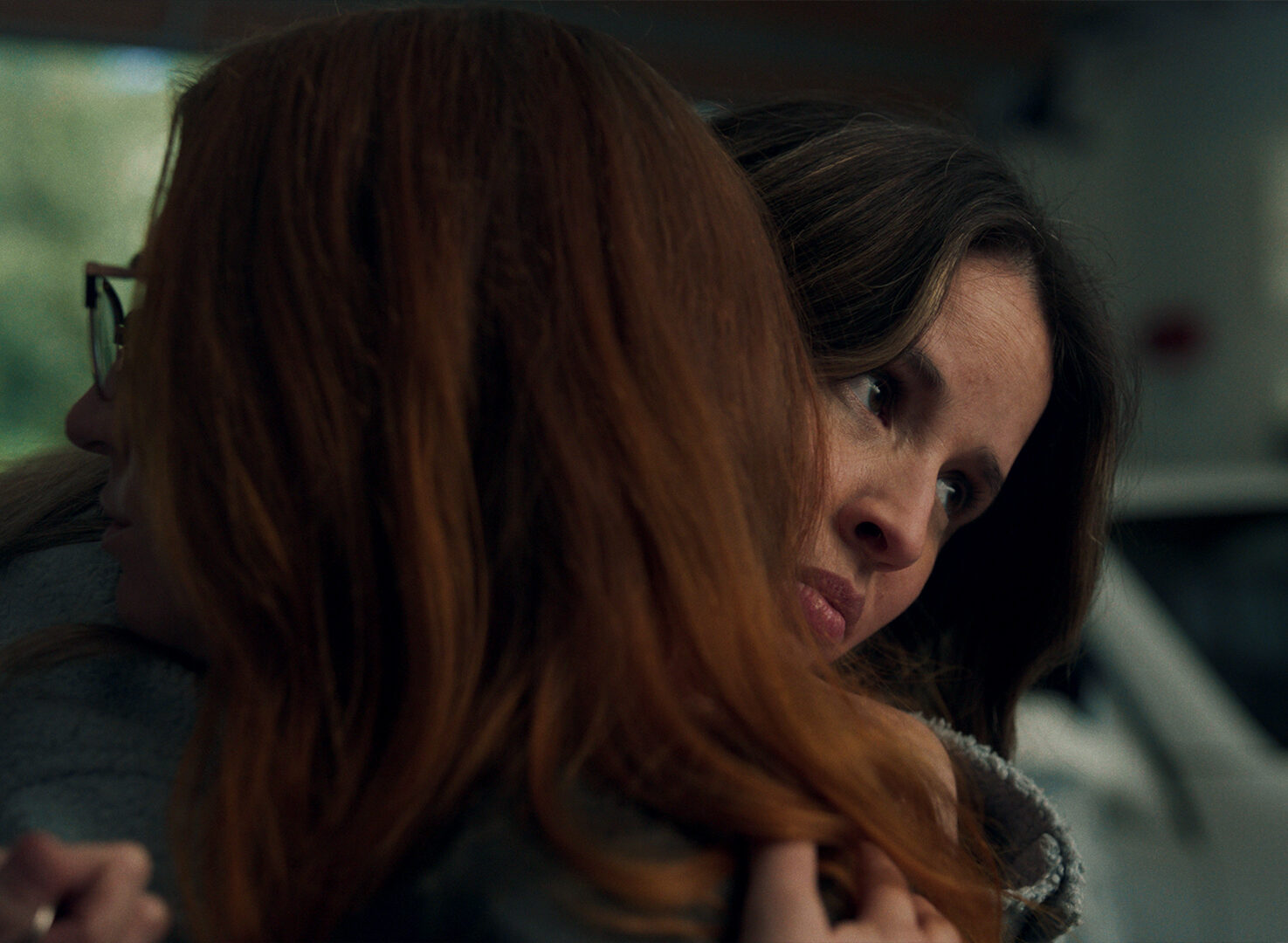 Two women hugging in a close up