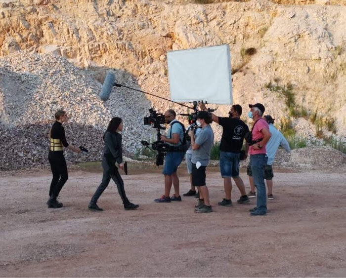 Walk n talk movie scene with steadicam operator leading talent. Large bounce card for fill light