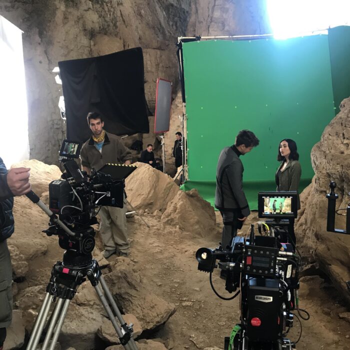 Large greenscreen in cave set up on movie set with two cameras