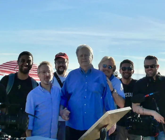 Group photo from Brian Wilson Long Promised Road documentary with Brian Wilson in the middle and film team around him