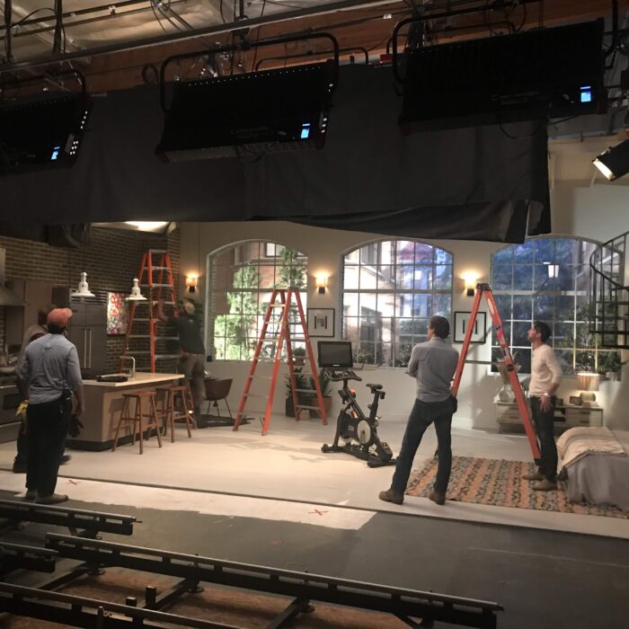 Film studio set of living with lights, and dolly tracks