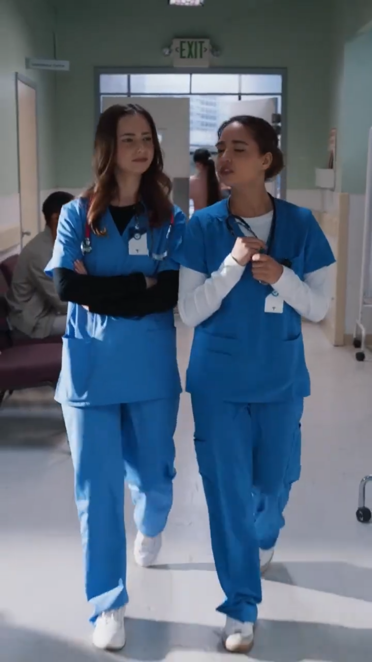 Two hospital nurses walking down a hospital corridor