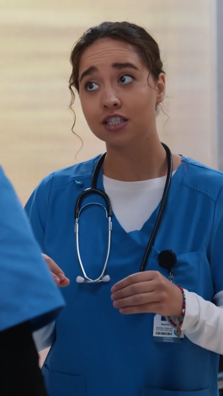 Close up of nurse in hospital gown talking to another nurse