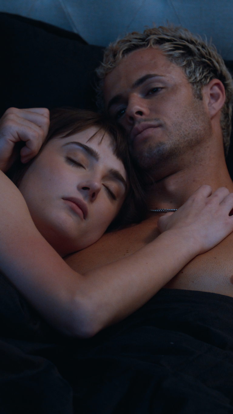 Tess Dinerstein leaning on chest of Jarod Staub in bed