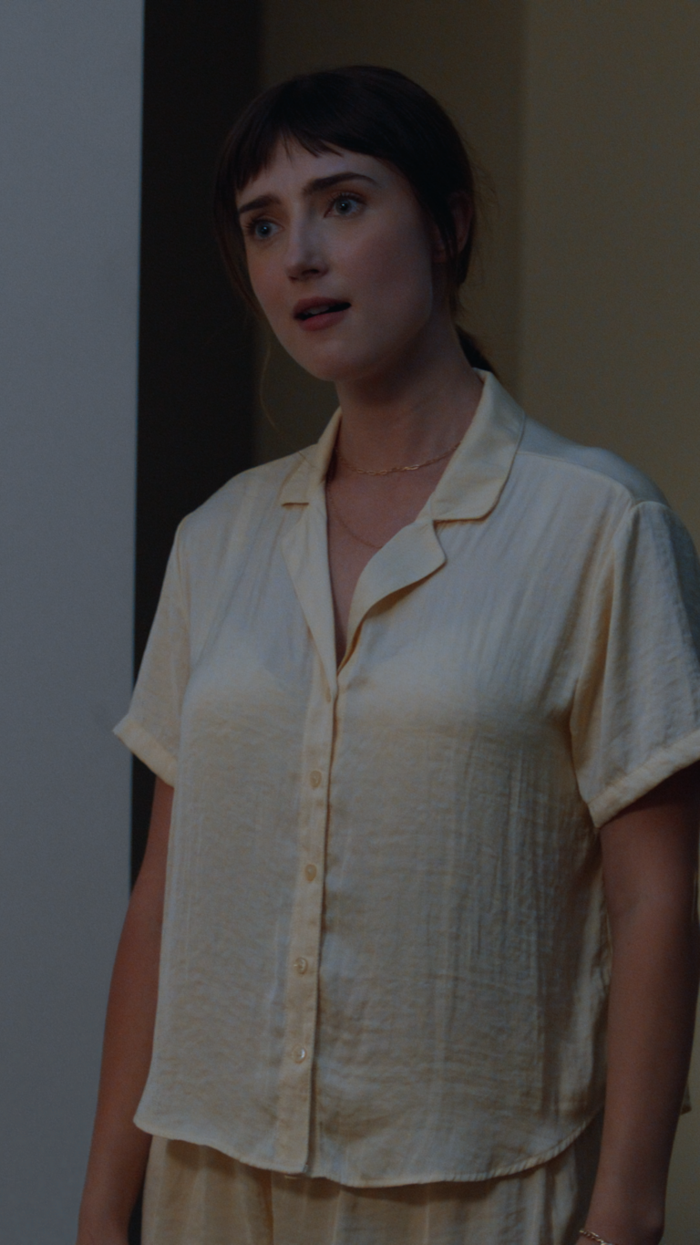 Tess Dinerstein in shirt standing in doorway
