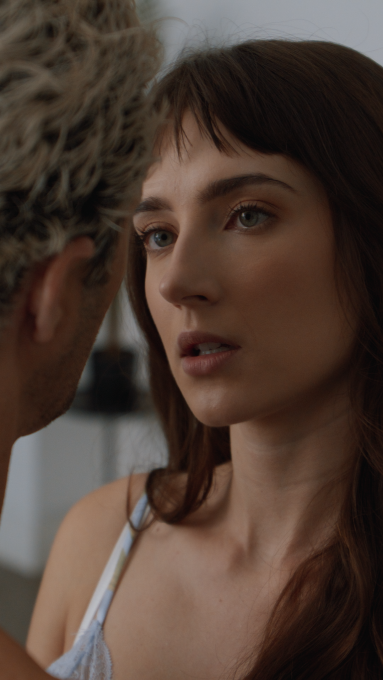 Close up of Tess Dinerstein looking at a man